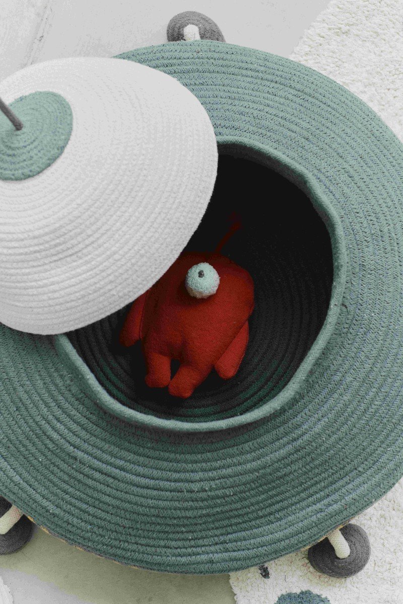 4. Top view of Lorena Canals UFO basket with open lid revealing red fabric alien inside