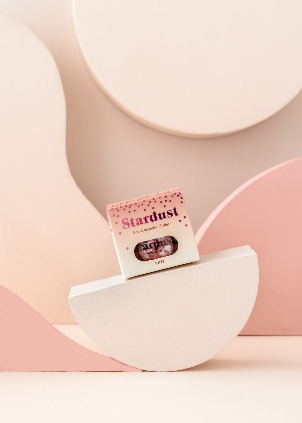 8. Pink eco glitter packaging displayed on geometric pink and white background