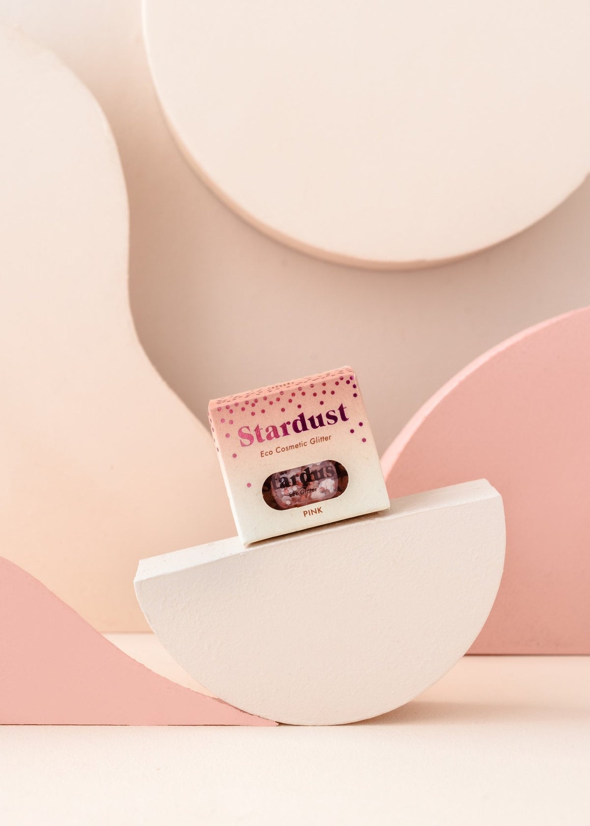 8. Pink eco glitter packaging displayed on geometric pink and white background
