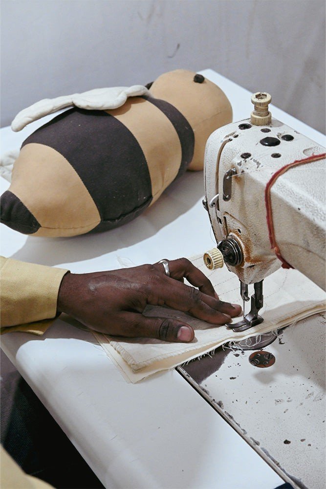 3. Close-up of sewing process for bee-shaped pillow with visible stitching details