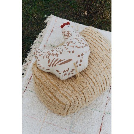 3. Beige chicken-shaped pillow with brown details on a textured beige cushion outdoors