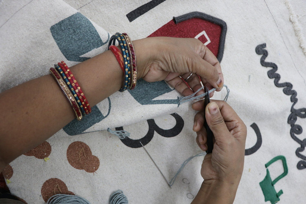 3. Close-up of hands crafting blue decorative basket watering can with cotton strings