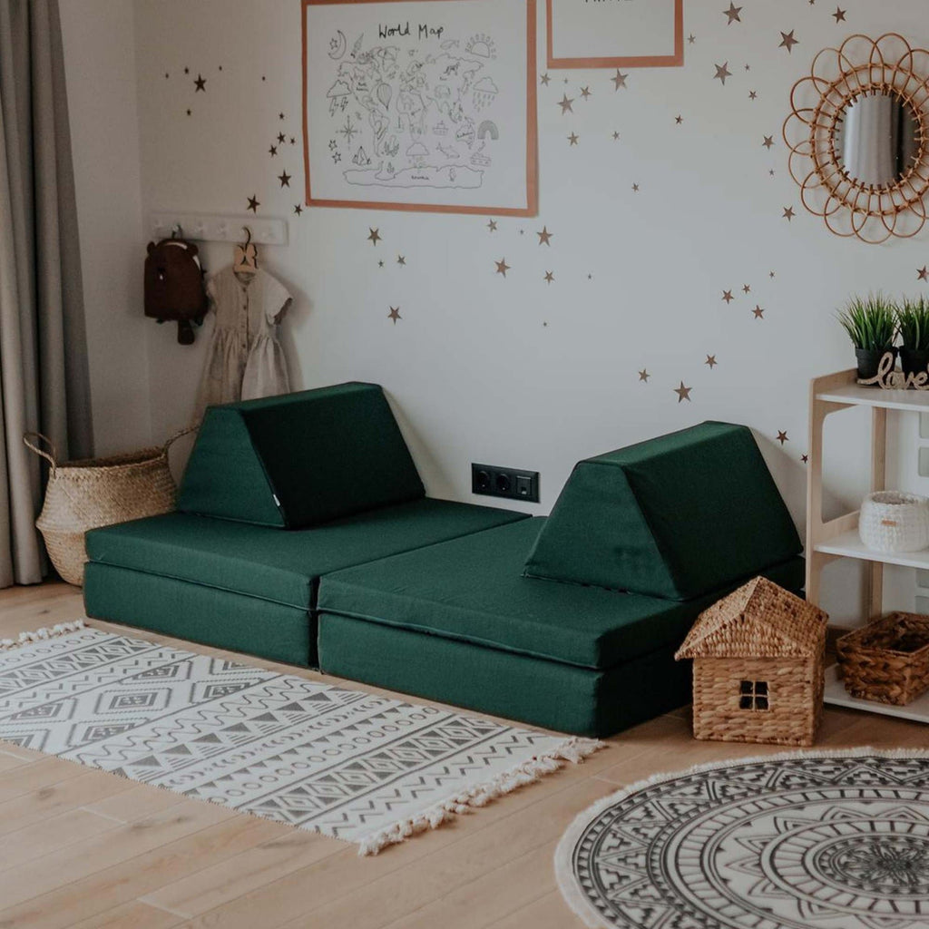 2. Monboxy deep green play mattress set in a living room with decorative elements