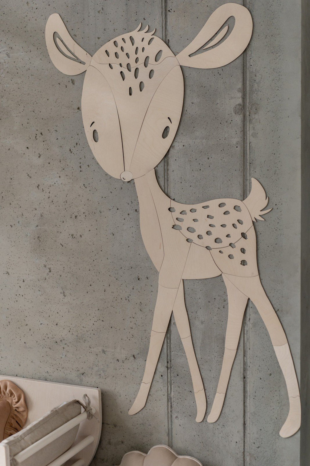 2. Close-up of deer wooden wall decoration on concrete wall, highlighting intricate cut design