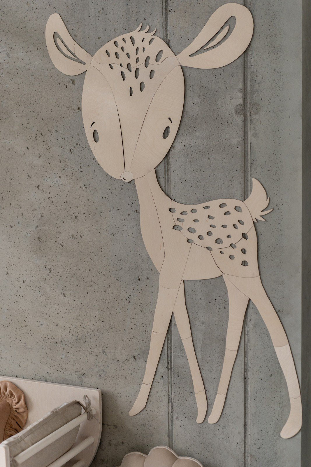 2. Close-up of deer wooden wall decoration on concrete wall, highlighting intricate cut design