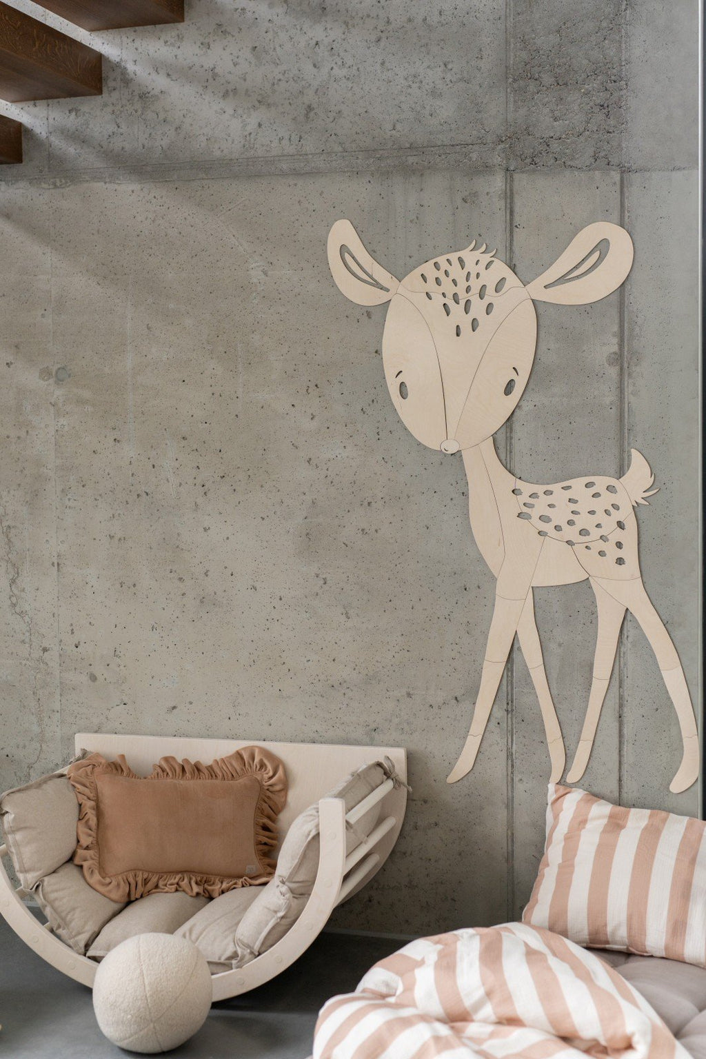 6. Deer wooden wall decoration in child's room with cozy seating and striped pillows