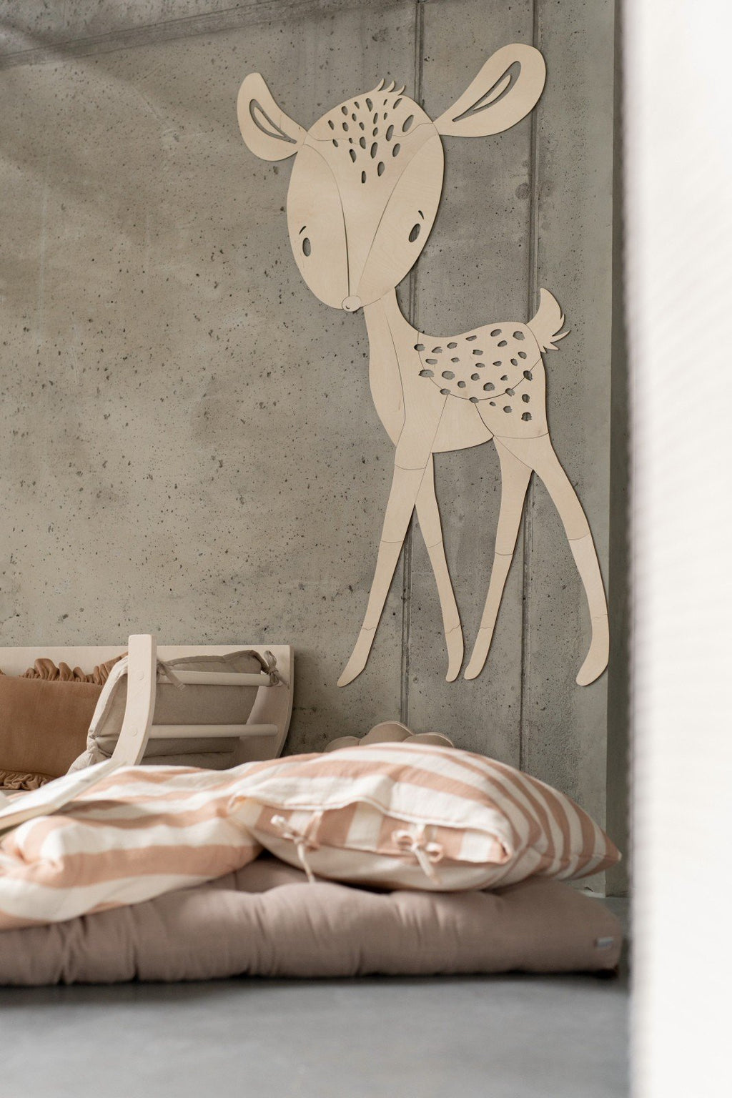 8. Deer wooden wall decoration above bed with striped bedding in child's room