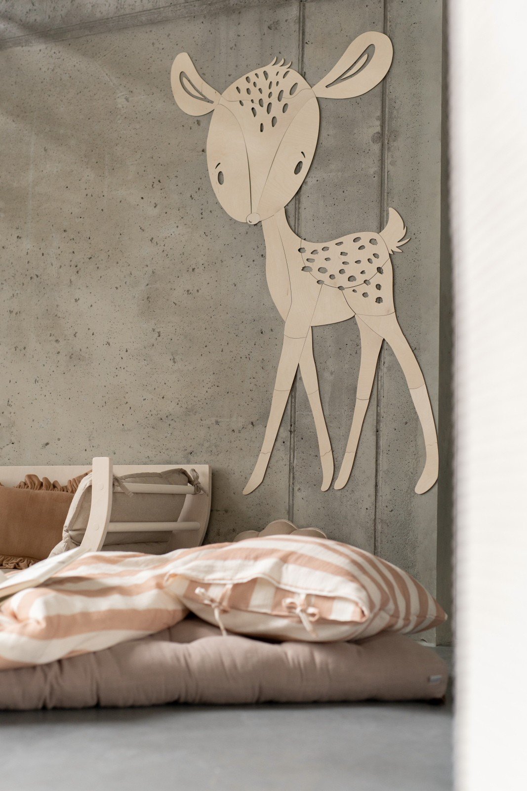 8. Deer wooden wall decoration above bed with striped bedding in child's room