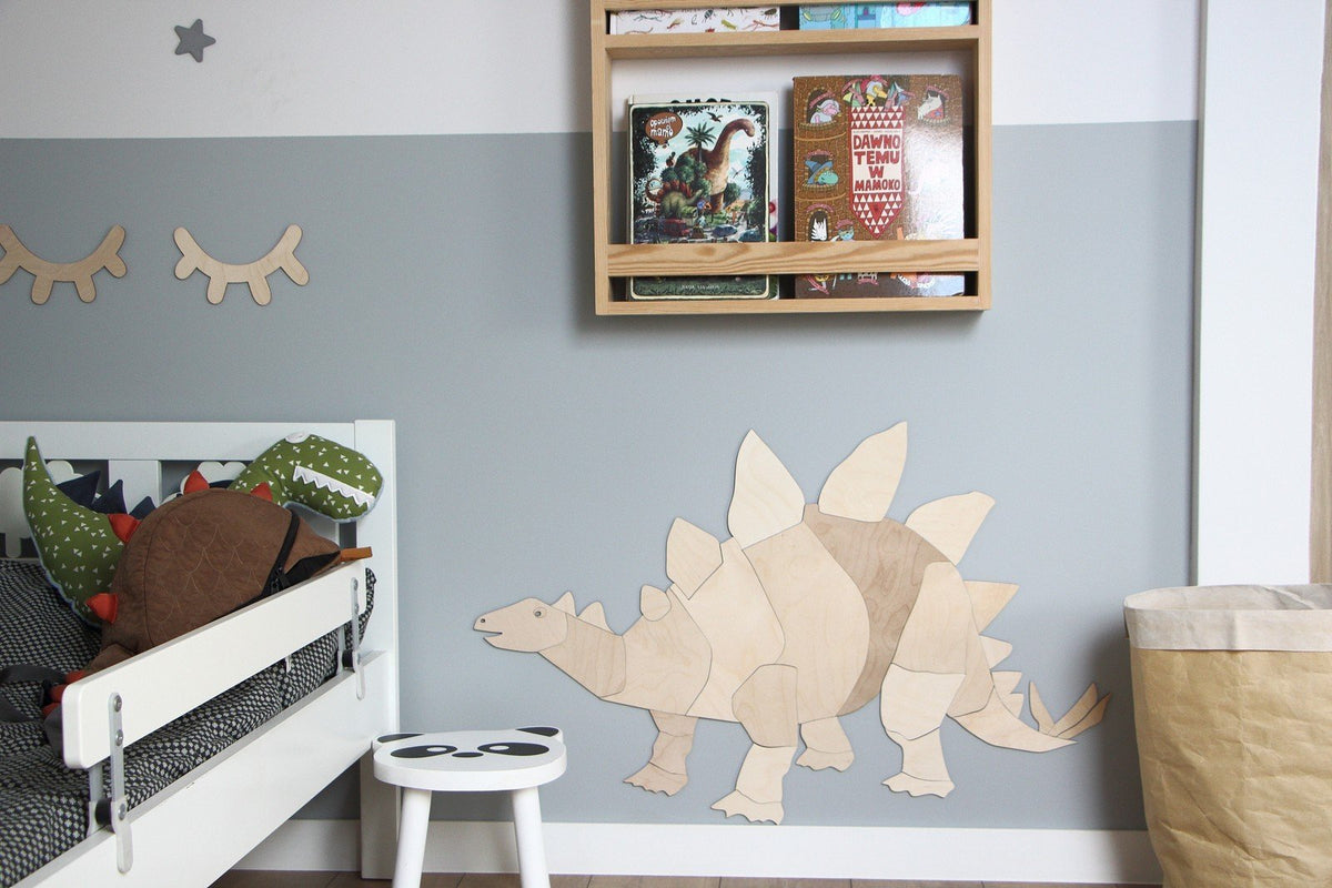 5. Wooden stegosaurus wall decoration in child's room with books and toys