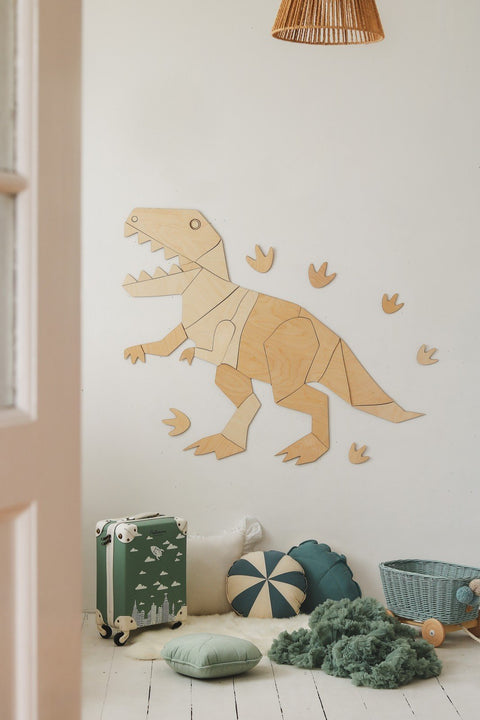 1. Wooden T-Rex wall decoration in children's room with pillows and suitcase, creating a playful atmosphere