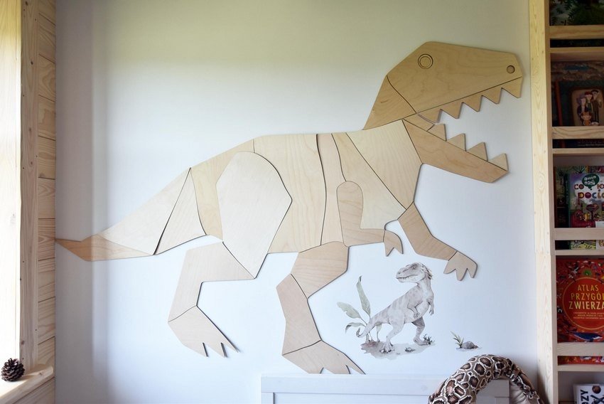 4. Close-up of wooden T-Rex wall decoration in child's room with bookshelf and toys, showcasing detail