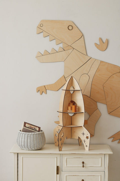 5. Wooden T-Rex wall decoration with rocket shelf and basket, complementing a child's room decor