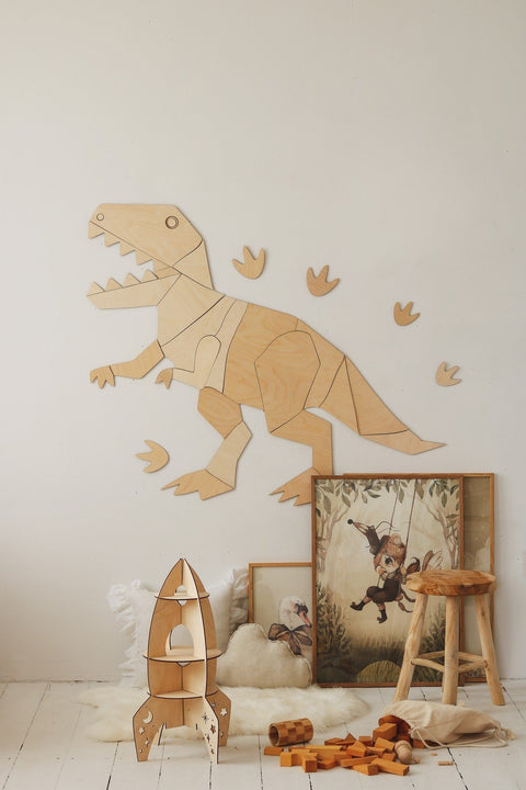 2. Wooden T-Rex wall decoration with children's toys and framed art, enhancing a cozy playroom