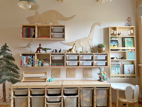 3. Children's room with wooden Triceratops wall decoration above shelves filled with books and dinosaur toys