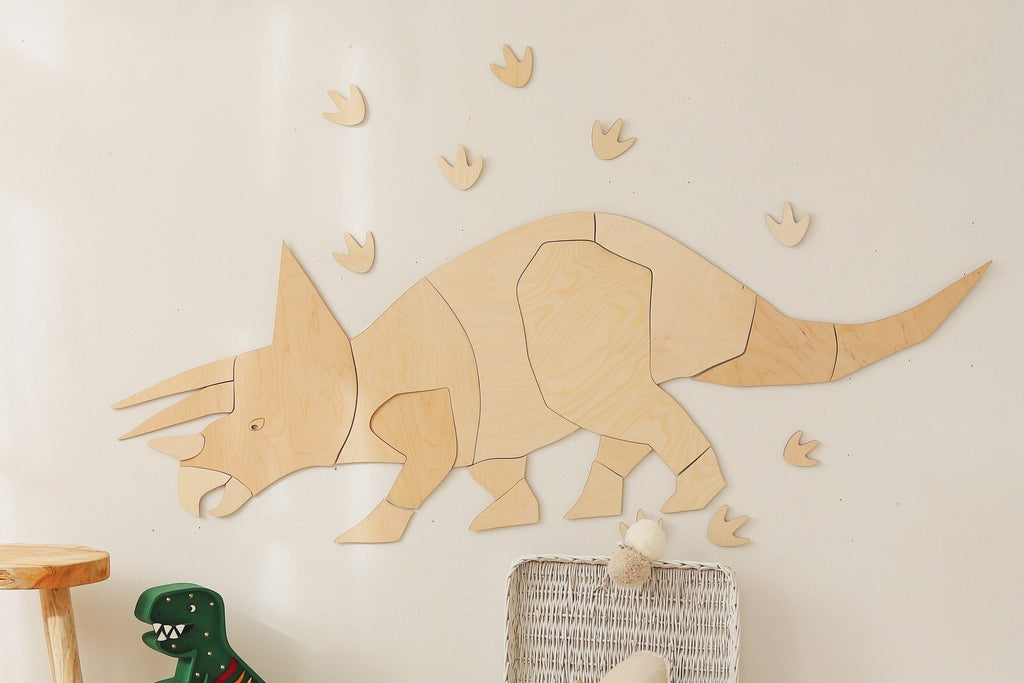 5. Wooden Triceratops wall decoration with puzzle-style assembly on white wall, surrounded by toy dinosaur and wicker basket