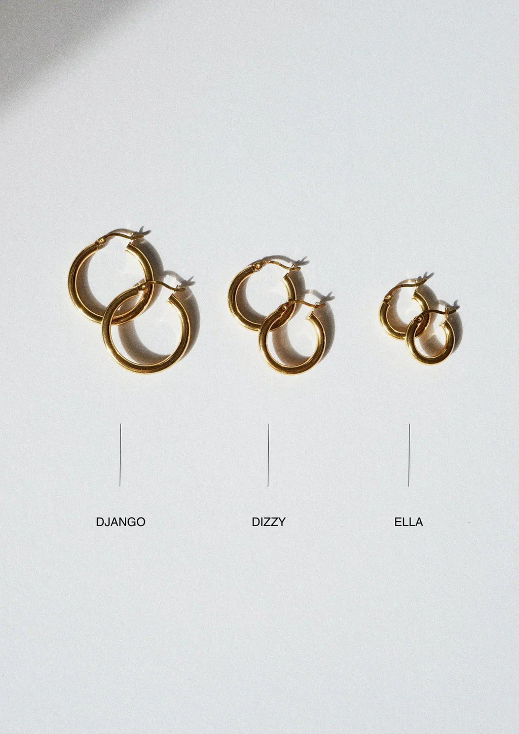 2. Flat lay of Django, Dizzy, and Ella gold hoop earrings by NO MORE on white background, highlighting size and style differences