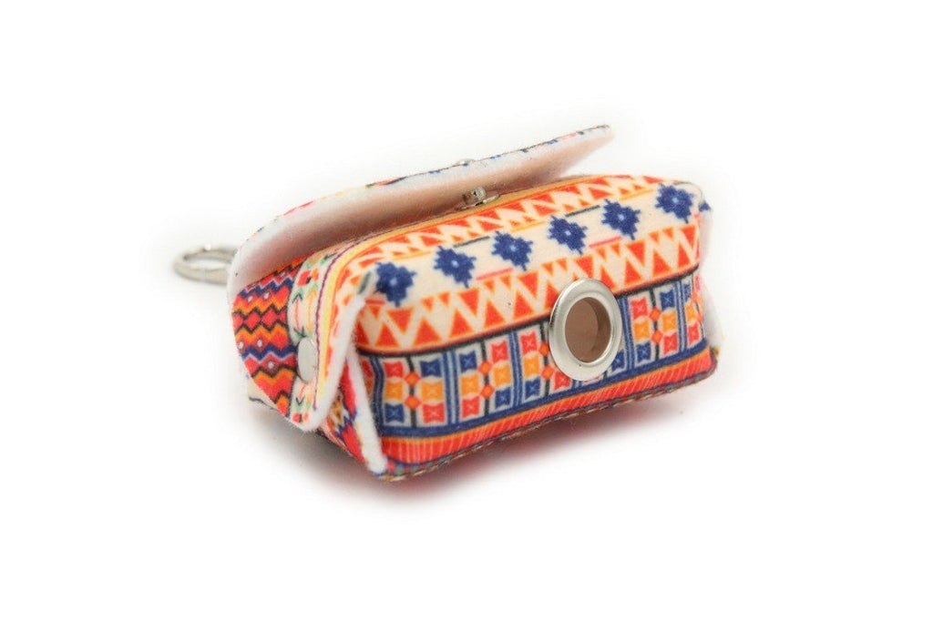 2. Studio shot of boho dog waste bag dispenser with vibrant geometric print and metal eyelet for bag dispensing