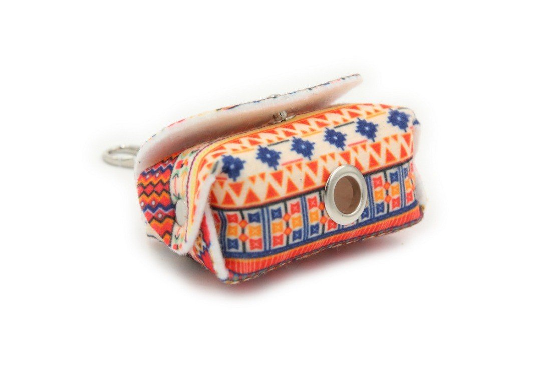 2. Studio shot of boho dog waste bag dispenser with vibrant geometric print and metal eyelet for bag dispensing
