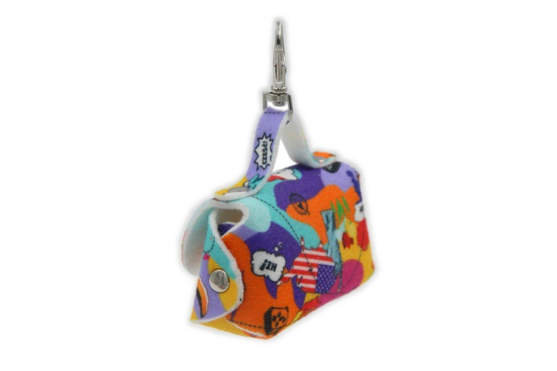 3. Side view of Matteo dog waste bag dispenser with colorful cartoon print and metal snap hook
