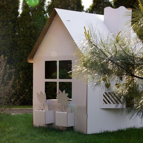 4. SEIK cardboard playhouse for kids in garden setting with window boxes and chimney