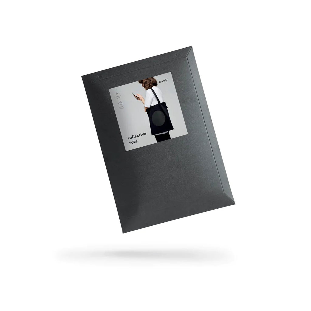 4. Black cardboard envelope packaging for MARCH Reflective Tote DOT, featuring product image