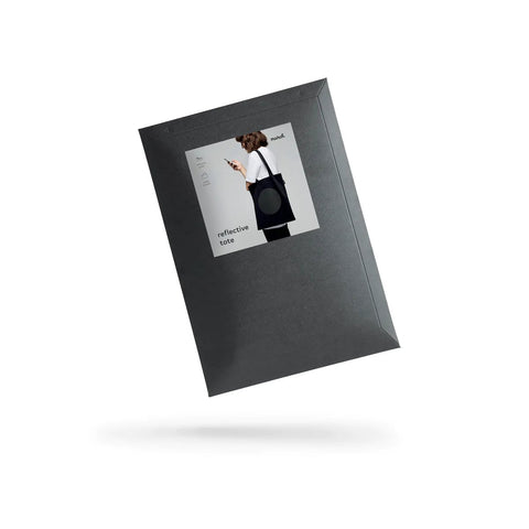 4. Black cardboard envelope packaging for MARCH Reflective Tote DOT, featuring product image