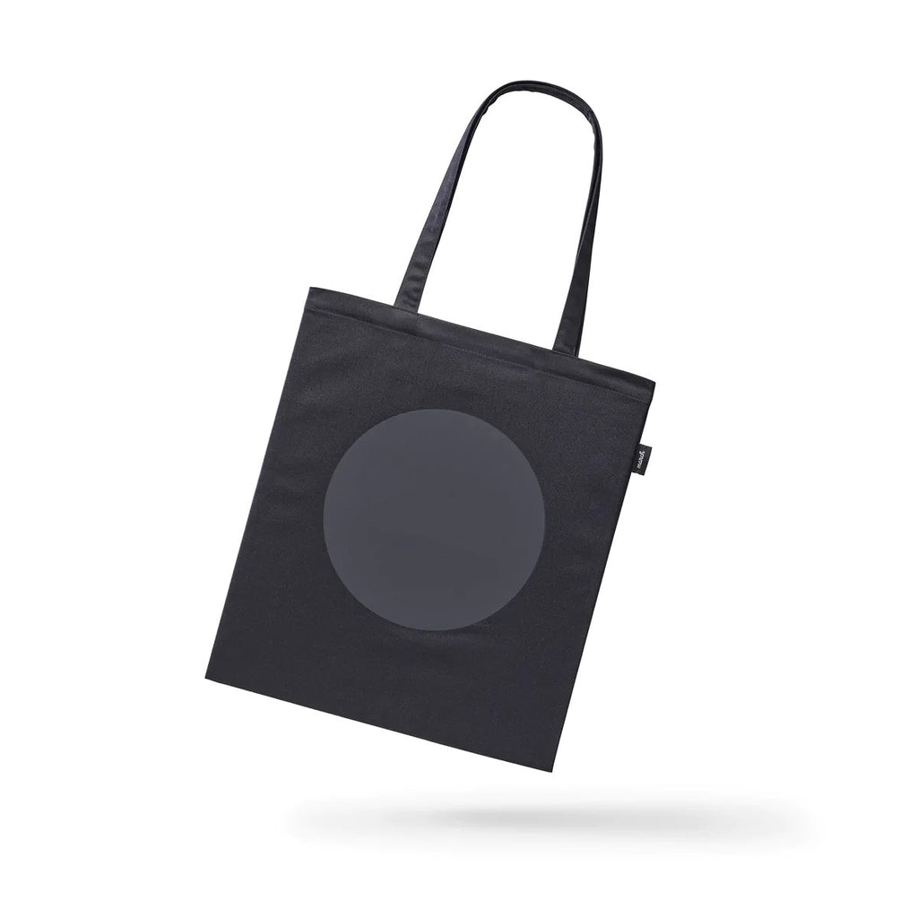 3. Studio image of MARCH Reflective Tote DOT, featuring reflective circle design on black fabric