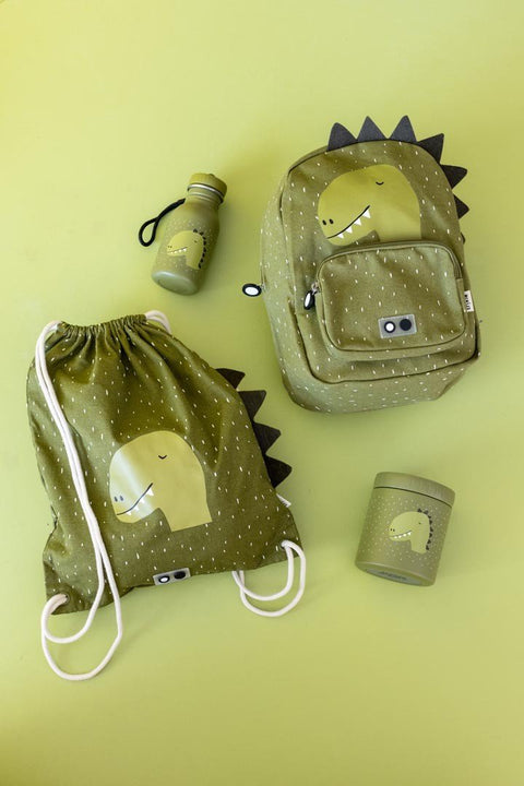 5. Flat lay of green dinosaur-themed drawstring bag, backpack, and water bottle on green background