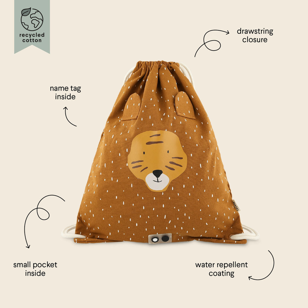 2. Trixie Baby Mr. Tiger drawstring bag with labeled features including name tag, small pocket, and water-repellent coating