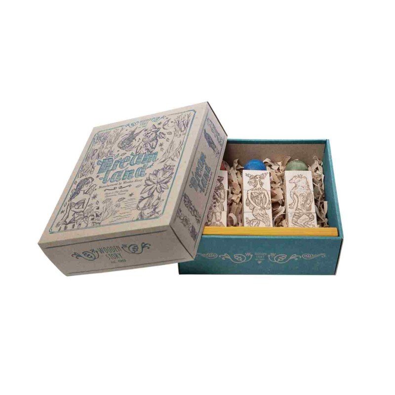 4. Open packaging of Wooden Story Dreamland Spinner Puzzle showing engraved blocks and colorful spheres inside