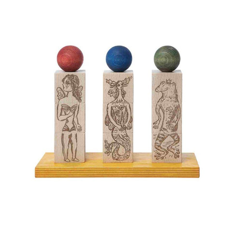 2. Wooden Story Dreamland Spinner Puzzle with three engraved blocks topped with colorful spheres on a wooden base