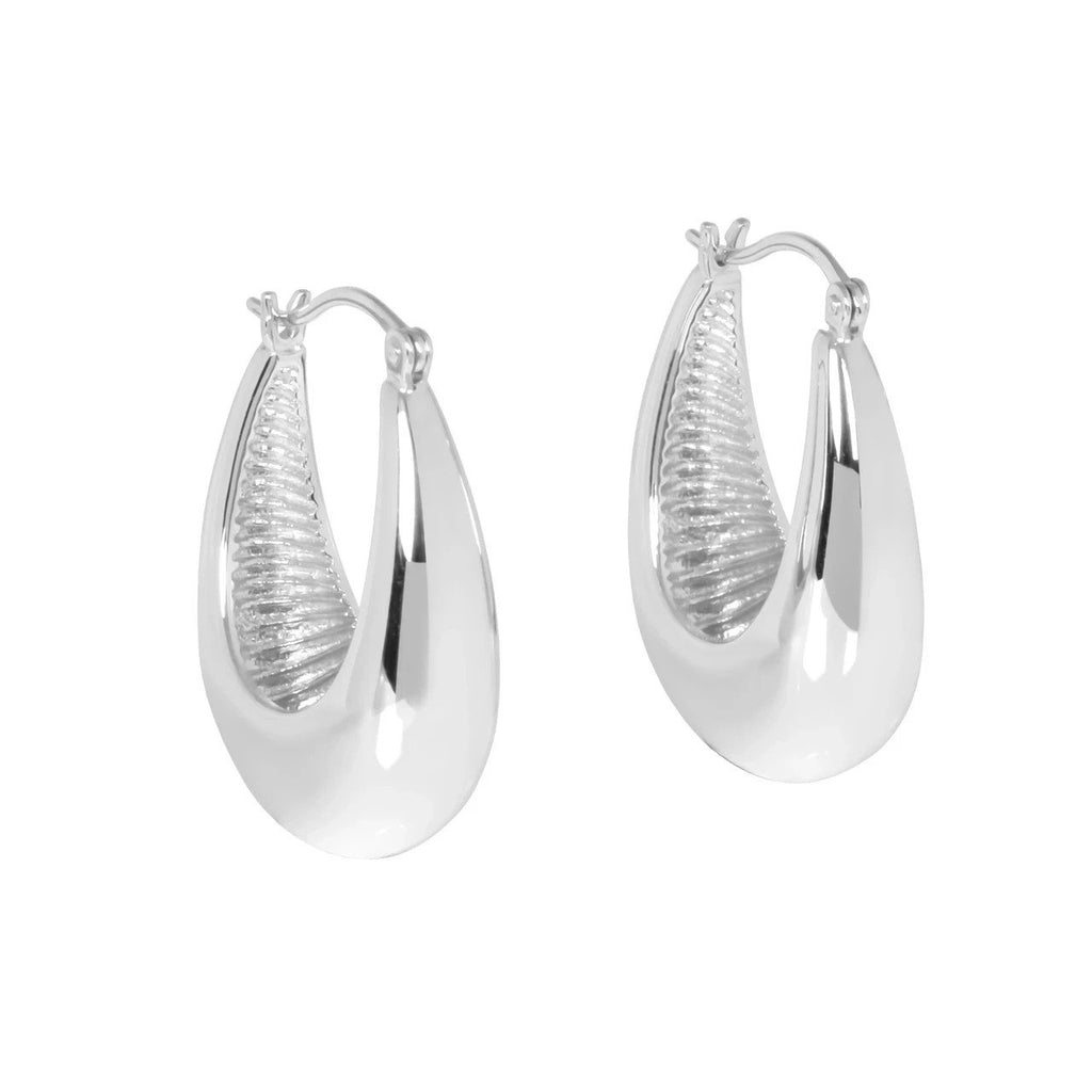 2. MyaMoon Penelope Hoops L Earrings in silver-toned rhodium plating, showcasing ultra-polished 25 mm hoops with a mirror-like surface and subtle wave pattern, displayed in studio setting