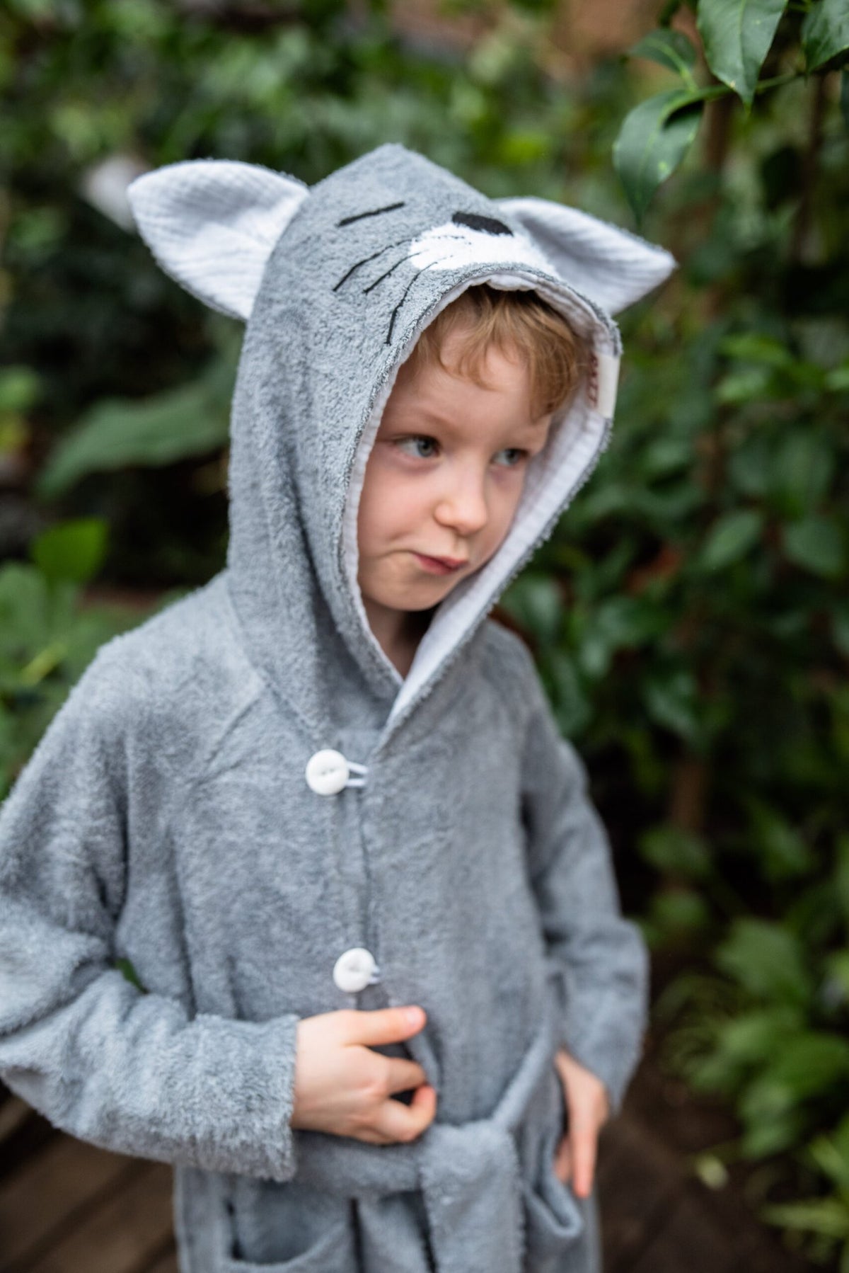 2. Boy in grey RÄTT CAT Bamboo Terry Bathrobe with hood and button closure, outdoors