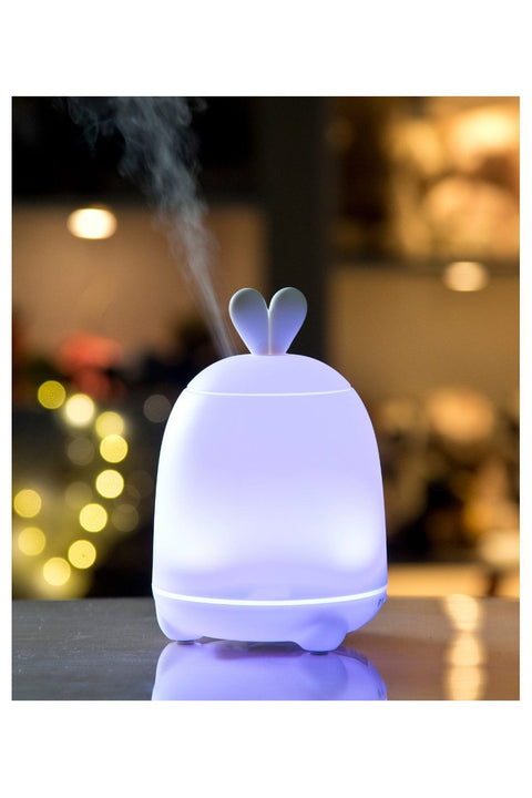 5. Purple-lit Rabbit & Friends diffuser lamp with bunny ears emitting mist in a softly lit environment