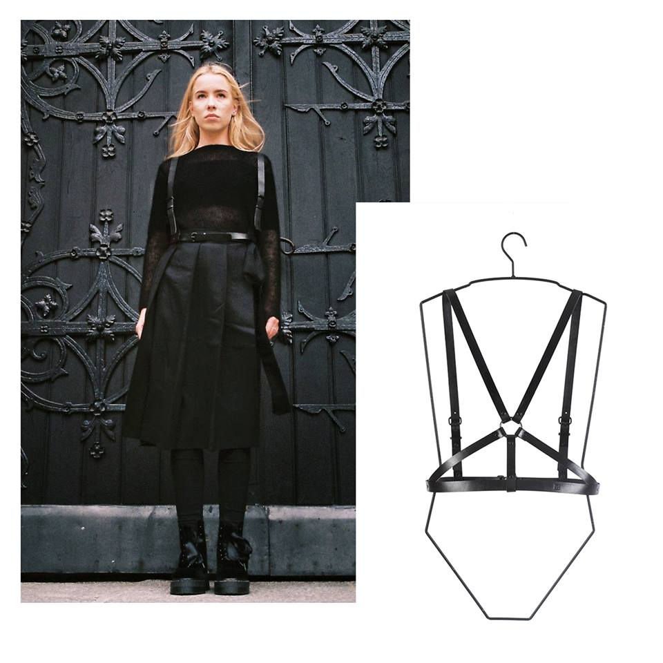 2. Woman in black outfit with RR Body Harness No 6, standing against ornate gate