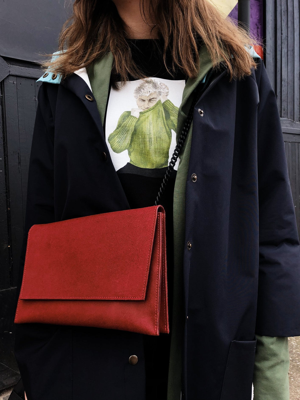 3. Woman wearing RR red chain shoulder bag with black coat, showcasing versatile style