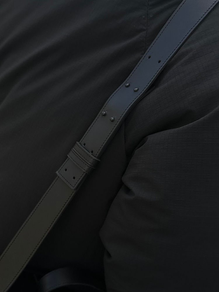 9. Close-up of black leather BOX Bag by RR, highlighting adjustable strap details and stitching