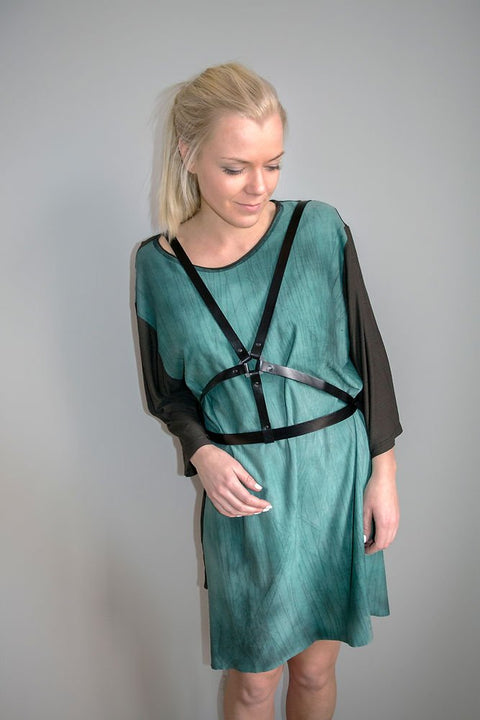 1. Woman wearing RR Body Harness No 6 over a green dress, showcasing versatile styling