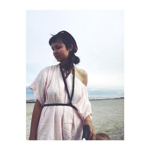 1. Women's black leather body harness by RR styled with red pants and black top, outdoor setting