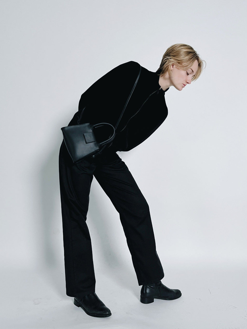 2. Women's mini leather handbag by RR worn cross-body, highlighting adjustable strap and structured design