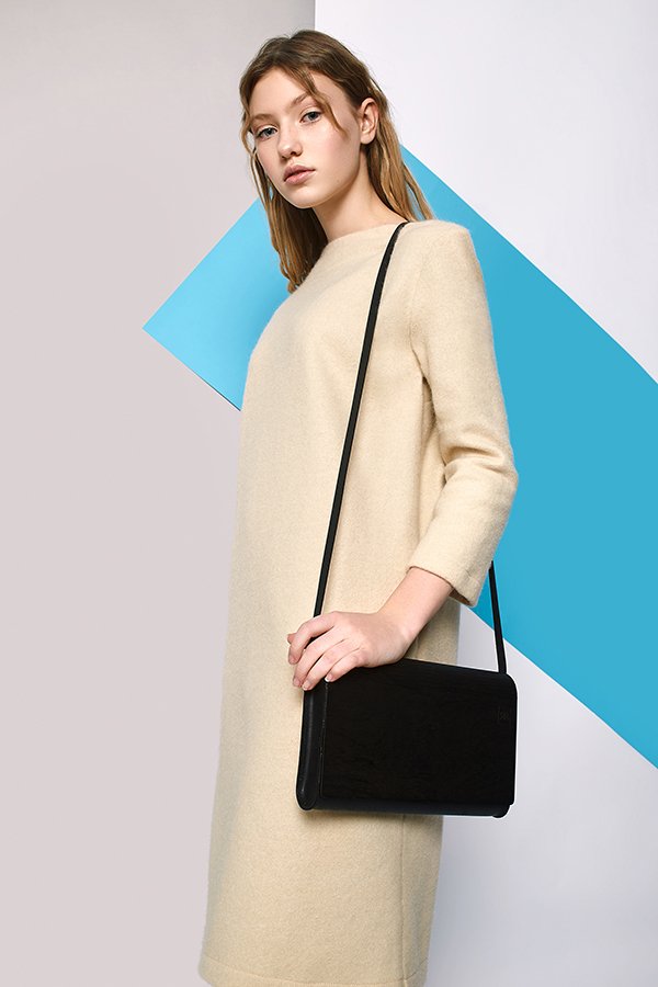 1. Women's large glossy wood clutch by RR worn with a black dress, showcasing elegant design