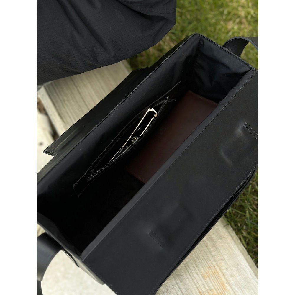 6. Interior view of black leather BOX Bag by RR, highlighting lined interior and wall pocket