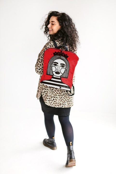 1. Woman wearing Garbanota red BACKPACK EGLE with unique artwork by Dovilė Aleksonė, shown in lifestyle setting