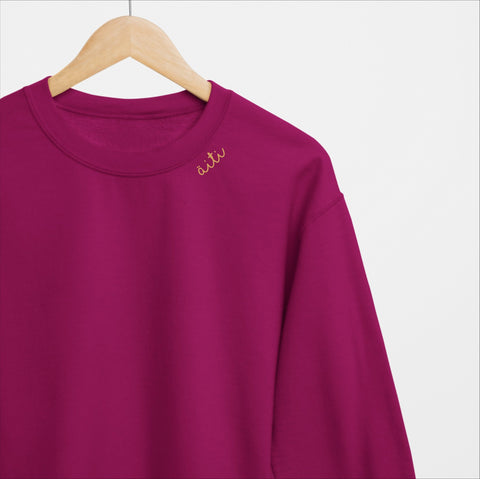 2. Unisex cherry Äiti sweatshirt with embroidered collar, displayed on a hanger in studio