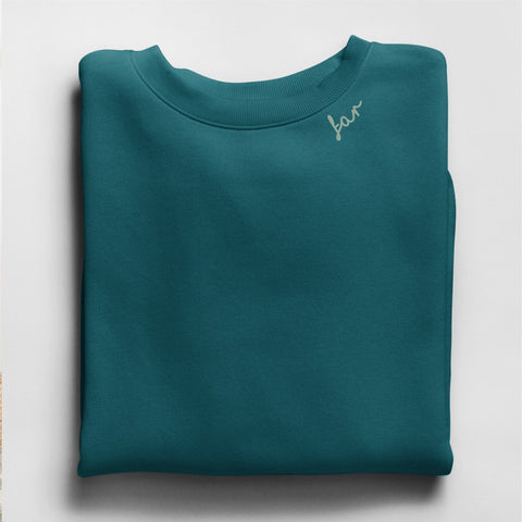 4. Flat lay of teal unisex sweatshirt with 'far' embroidery on collar