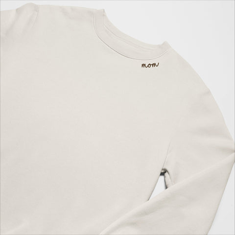 4. Beige unisex organic cotton sweatshirt with 'Mom' embroidery on collar, laid flat