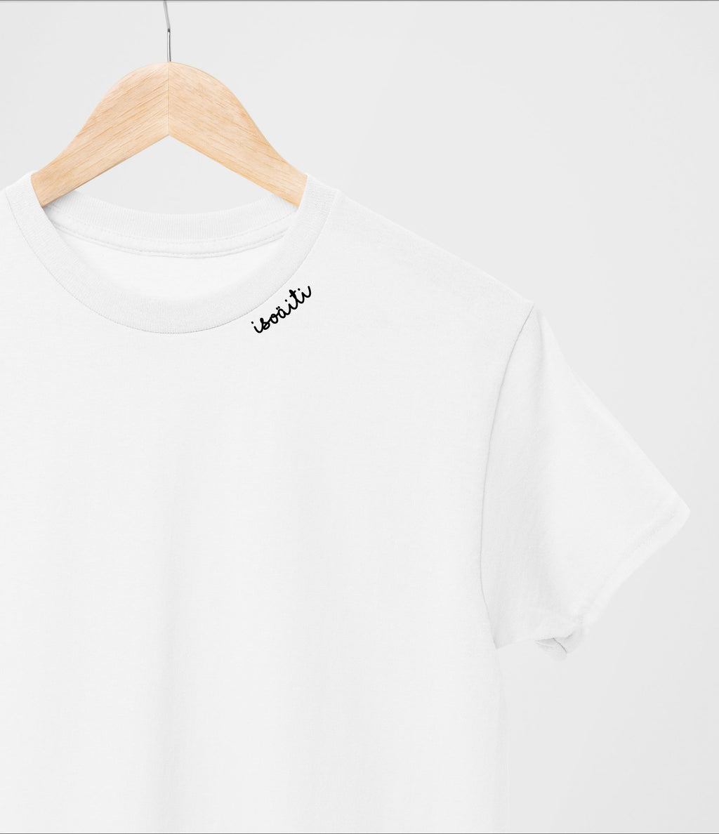 1. White unisex organic cotton t-shirt with embroidered collar by Beebila, shown on hanger in studio
