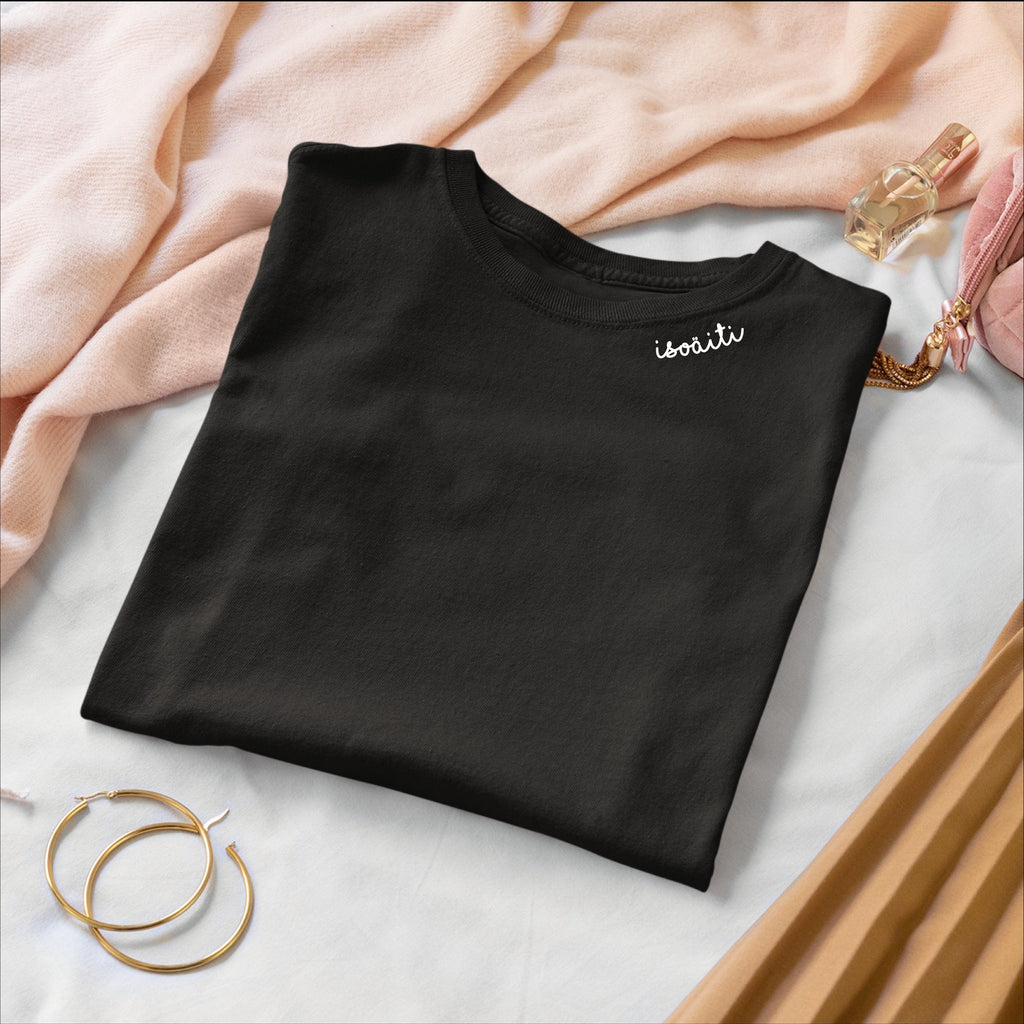 2. Black unisex organic cotton t-shirt with embroidered collar by Beebila, folded in lifestyle setting
