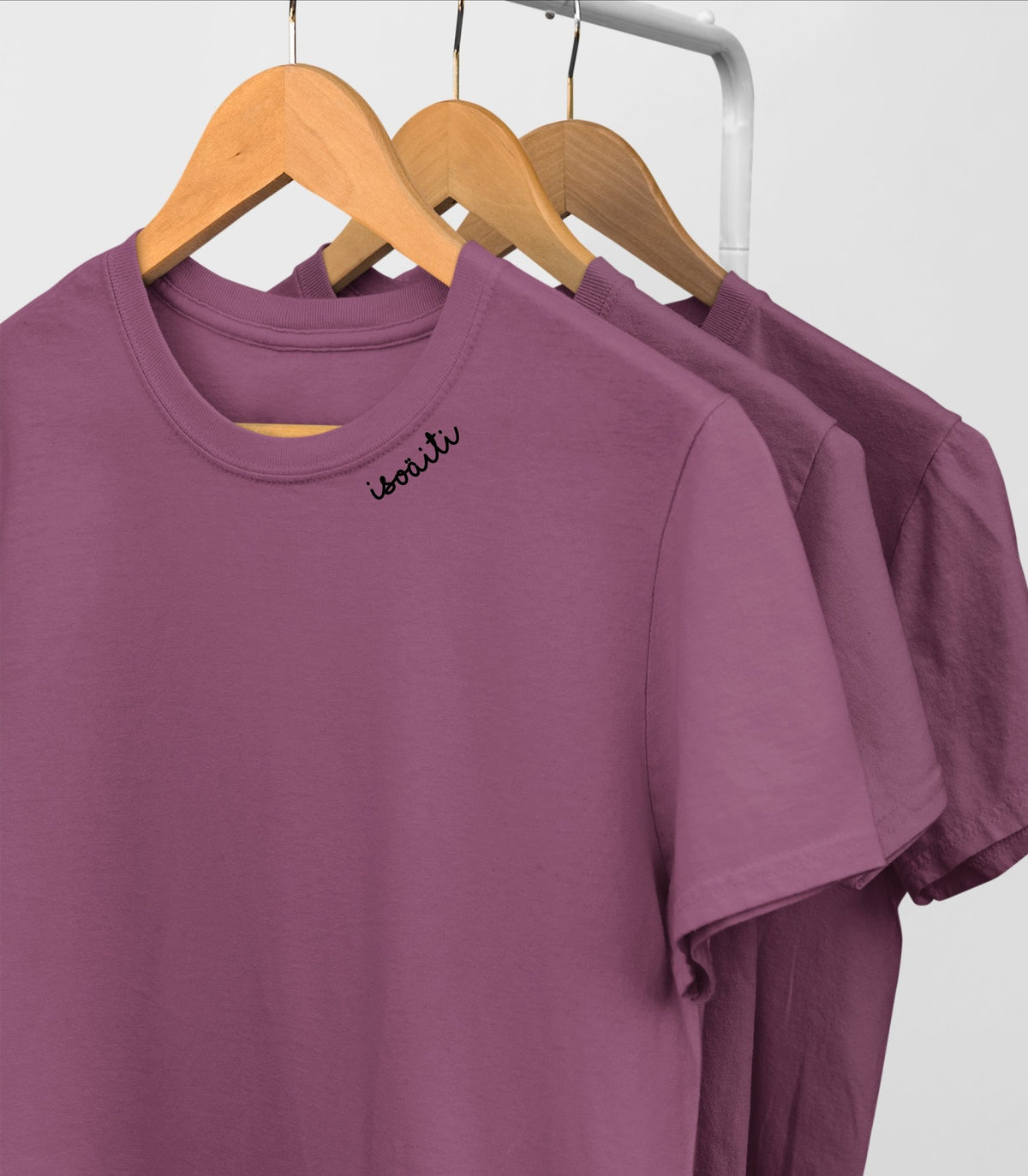3. Purple unisex organic cotton t-shirts with embroidered collars by Beebila, displayed on hangers