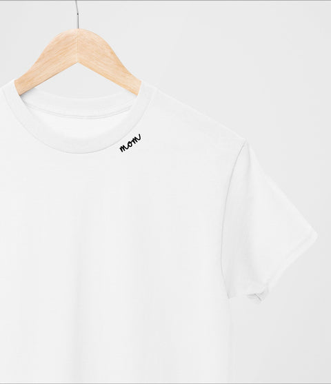 2. White organic cotton t-shirt with 'mom' embroidery on hanger in studio